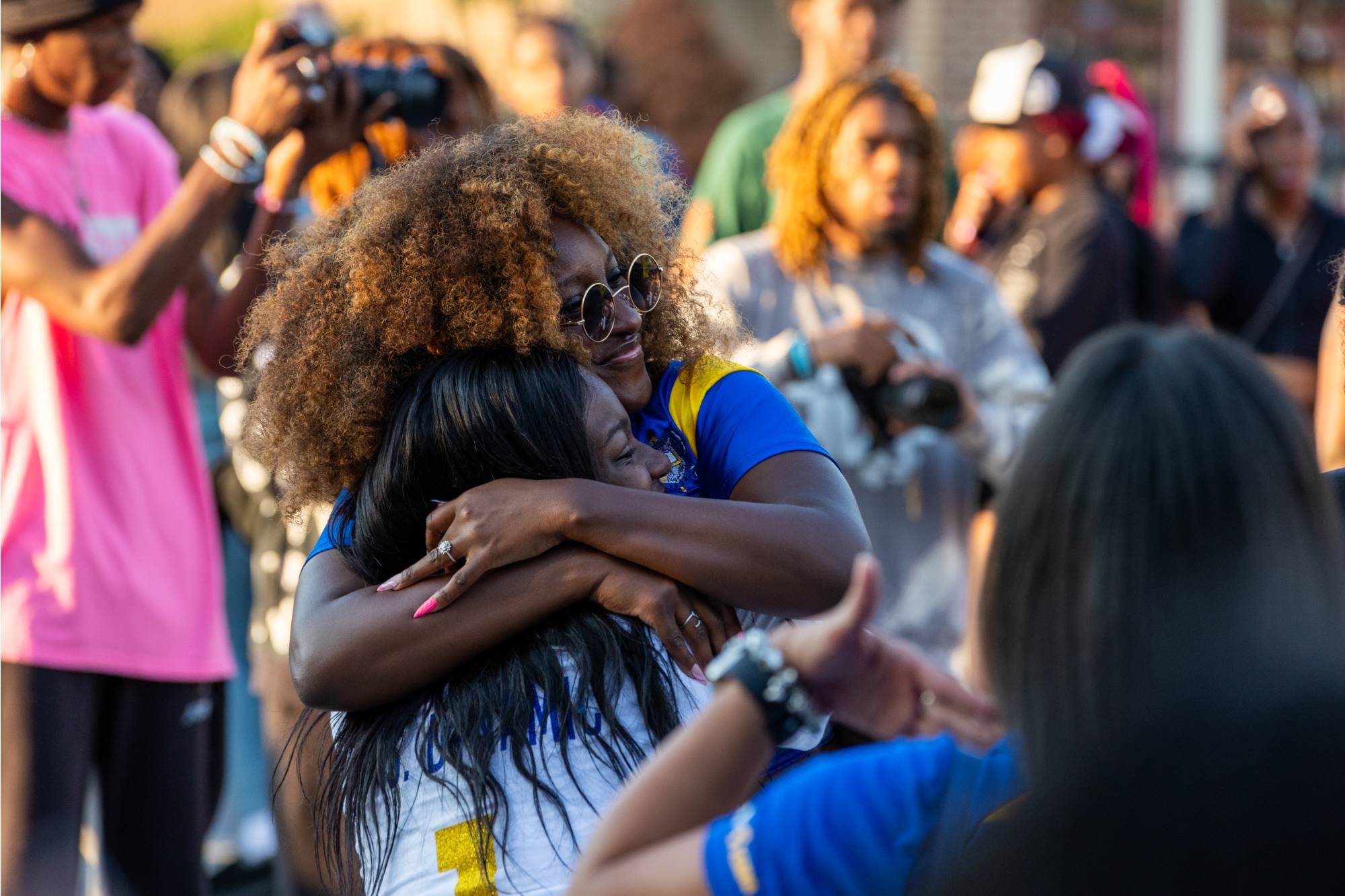 Two students hugging at the NPHC Yard Show